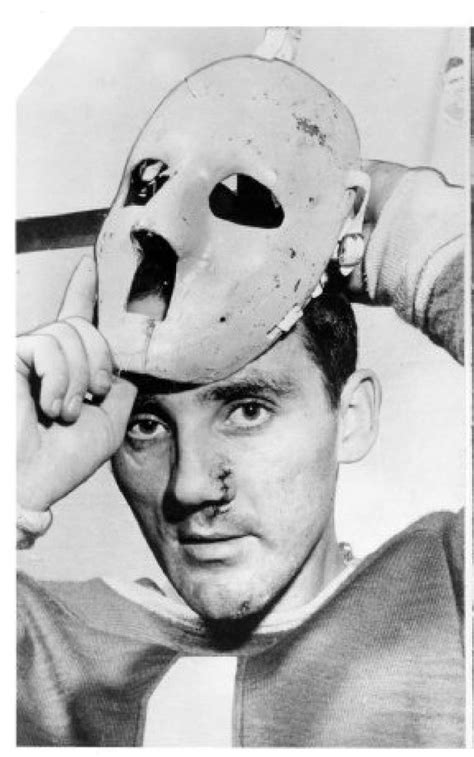 A battered Jacques Plante puts on his famous goalie mask which he ...