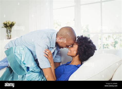 Happy Couple Nose To Nose On The Sofa Stock Photo Alamy