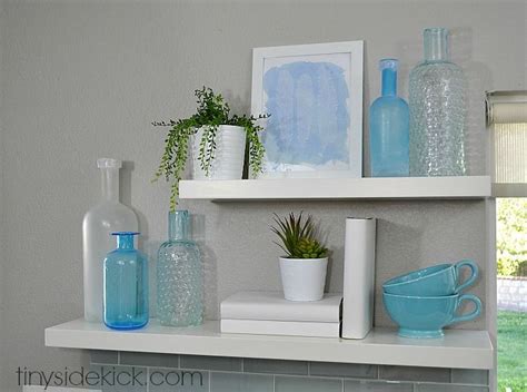 The Shelves Are Filled With Vases Bottles And Other Decorative Items In Blue Colors