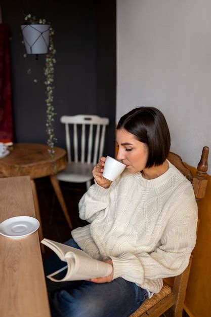 Premium Photo | Person in a cafe reading a book while having coffee