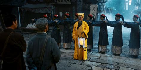 Taoist Priest Praying At The Temple Of The Town Gods Or Off