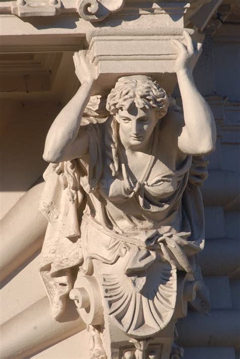 Caryatid Sculpture Adorns The Facade Of The Old House On The Street Of