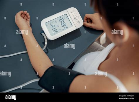 Pregnant Woman Measuring Her Blood Pressure During The Third Trimester