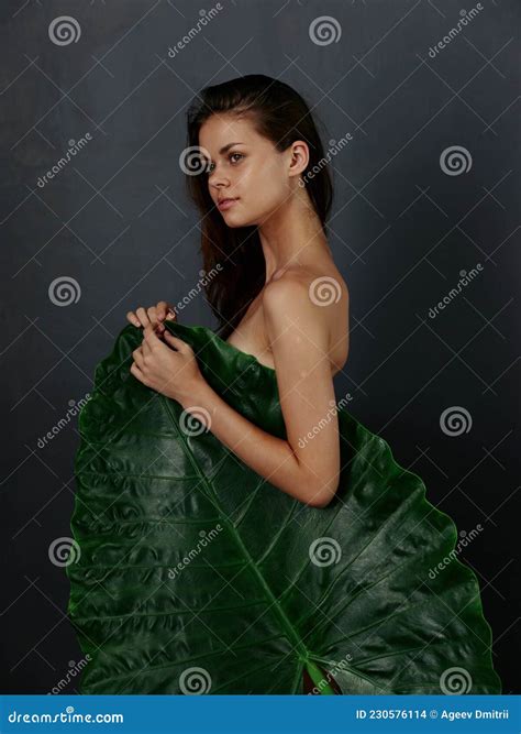 Pretty Woman With Naked Body Is Covered By A Large Green Leaf Dark