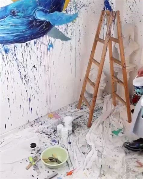 An Artist S Studio With Paint And Brushes On The Floor Next To A Ladder