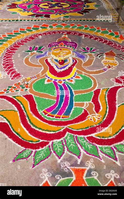 Dasara Rangoli festival coloured powder design outside a hindu temple. Puttaparthi, Andhra ...