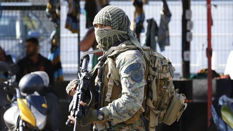 Brazilian Bope Officer Patrolling The Streets Of A Favela In Rio De