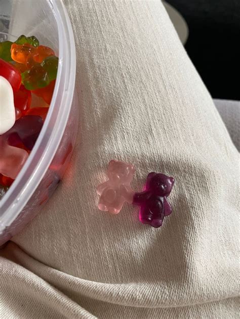 A Plastic Container Filled With Gummy Bears Sitting On Top Of A White