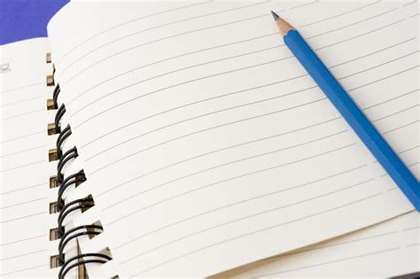 Free Stock Photo 5394 Pencil lying on a blank notebook | freeimageslive