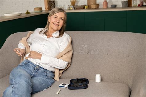 Mature Diabetic Woman Making Insulin Injection And Looking Concentrated