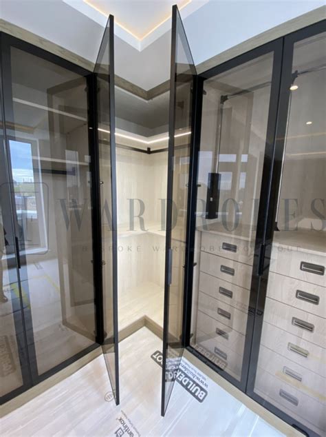 Bespoke Dressing Room With Italian Brown Tinted Glass Doors And The Island Contemporary