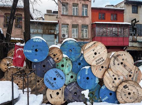 Old Cable Reels Stacked In Front Of Old Photograph by Peter Eastland ...