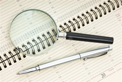 Pen and magnifying glass stock photo. Image of making - 16557078 