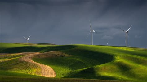 Wind Turbines On Green Grass Hills Under Cloudy Sky Hd Nature