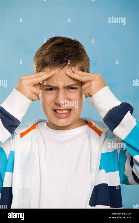 boy touching forehead stock photo alamy