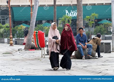 Two Muslim Women Indonesian Walking In The Fatahillah Square At Old