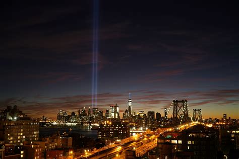 new york citys brooklyn bridge and city skyline with lights glowing at ...