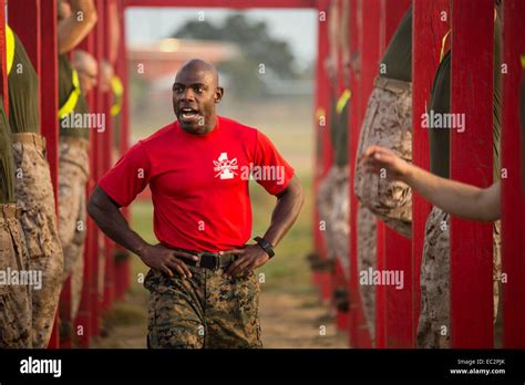 A Us Marine Drill Instructor Motivates Recruits During Physical