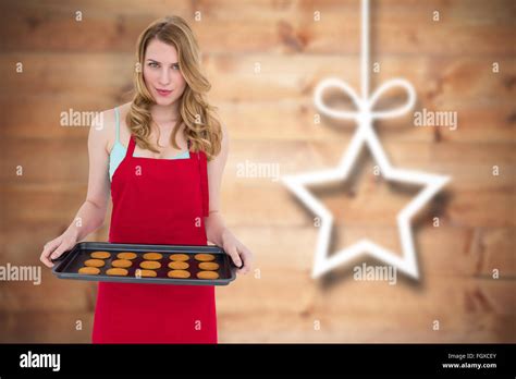 Composite Image Of Pretty Blonde Showing Hot Cookies Stock Photo Alamy