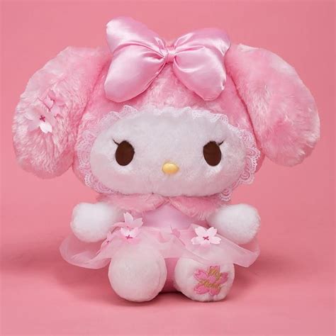 a pink hello kitty stuffed animal on a pink background