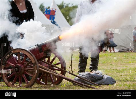 Medieval woman firing a cannon at the re-enactment of the battle of ...