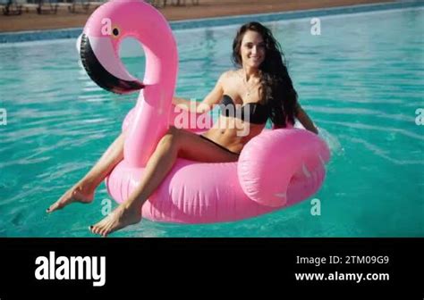 Sexy Woman In Bikini Enjoying Summer Sun And Tanning During Holidays In Pool With Cocktail