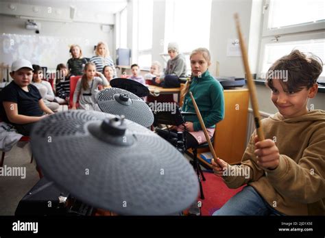 Children playing drums at school Stock Photo - Alamy