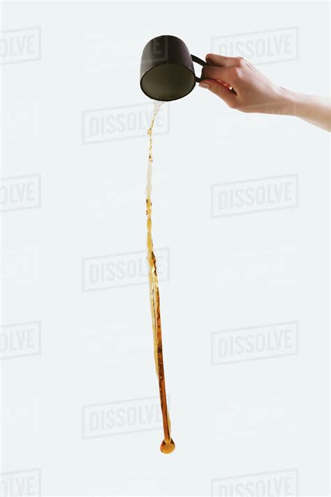 Cropped View Of Hand Pouring Out Coffee Isolated On White Stock