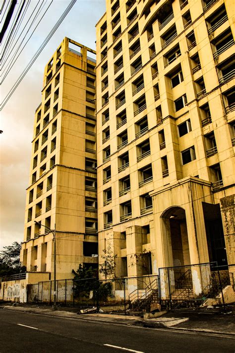 A Very Tall Building Sitting Next To A Street Photo Free Philippines