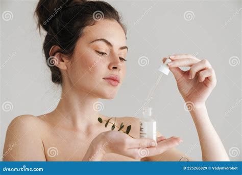 Half Naked Brunette Woman Showing Face Serum And Eucalyptus Stock Image