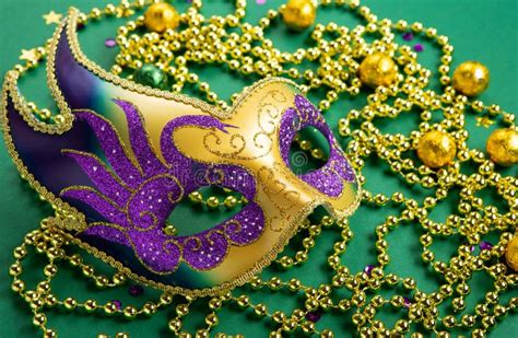 Mardi Gras Carnival Masks Gold Beads On Green Background Stock Image