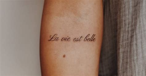 La Vie Est Belle Lettering Tattoo On The Inner