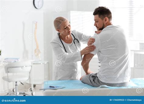 Male Orthopedist Examining Patient`s Arm Stock Image Image Of Mature