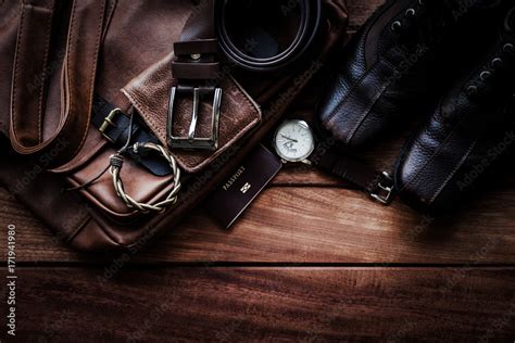 Men S Leather Accessories And Passport On Rustic Wooden Background