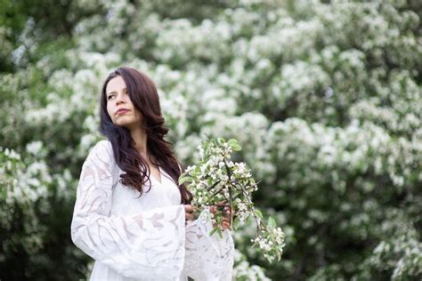 Premium Photo Sensual Brunette In Transparent White Dress Attractively Poses With Flowering
