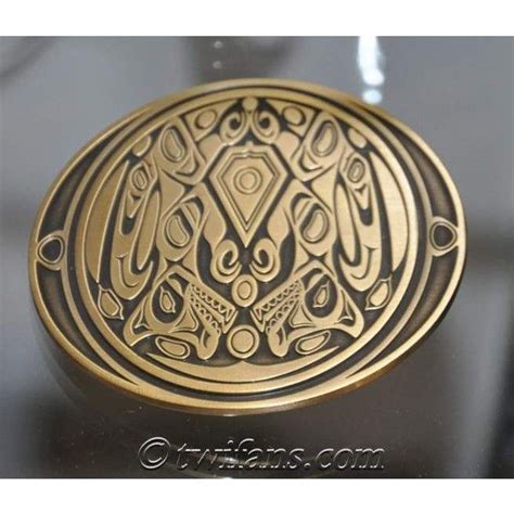 an intricately designed brass belt buckle on a black surface with gold ...