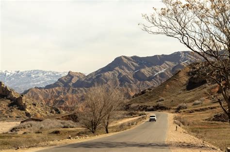 Una Carretera En Las Monta As Con Un Coche Circulando Por Ella Foto