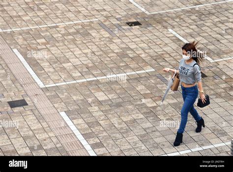 A Japanese woman wearing a mask Stock Photo - Alamy