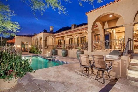 An Outdoor Dining Area Next To A Swimming Pool And Covered Patio With