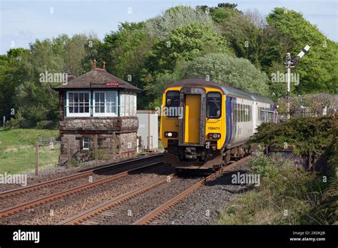 Northern Rail Class 156 Sprinter Train At Arnside With The Signal Box And Signals On The