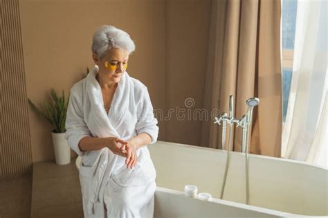 Mature Adult Old Woman Applying Moisturizing Body Lotion On Hands Senior Lady Rubbing