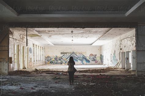 Young Woman Urban Exploring An Old Building With Her Camera By Stocksy Contributor Pixel