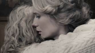 Blonde Woman Wrapped In A Sweater