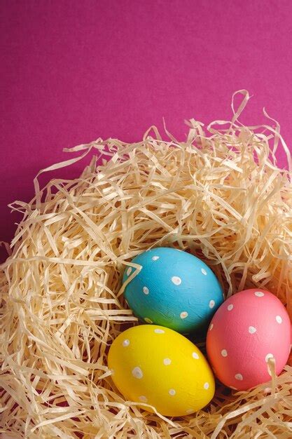 Premium Photo Colorful Polka Dot Easter Eggs In Wooden Nest On Pink