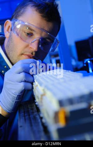 Scientist Placing Some Test Tubes Into The Centrifuge Scientist