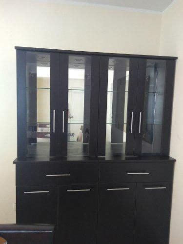 A Black Cabinet With Glass Doors In A Living Room