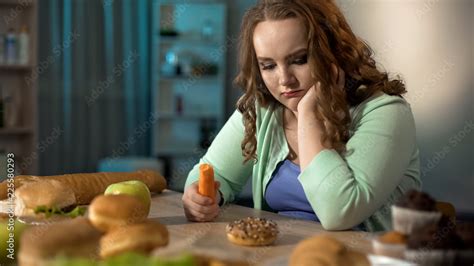 Sad Fat Girl Eating Carrot And Dreaming About Sweet Donut Healthy