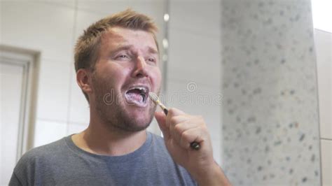A Handsome Gay Man Brushes His Teeth In The Morning In The Bathroom Stock Video Video Of Life