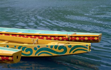 Detail Of Three Yellow Indonesian Decorated Canoes In The Sea Stock