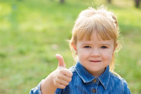 Portrait Of Happy Little Girl With Smile On Face On Sunny Day Stock